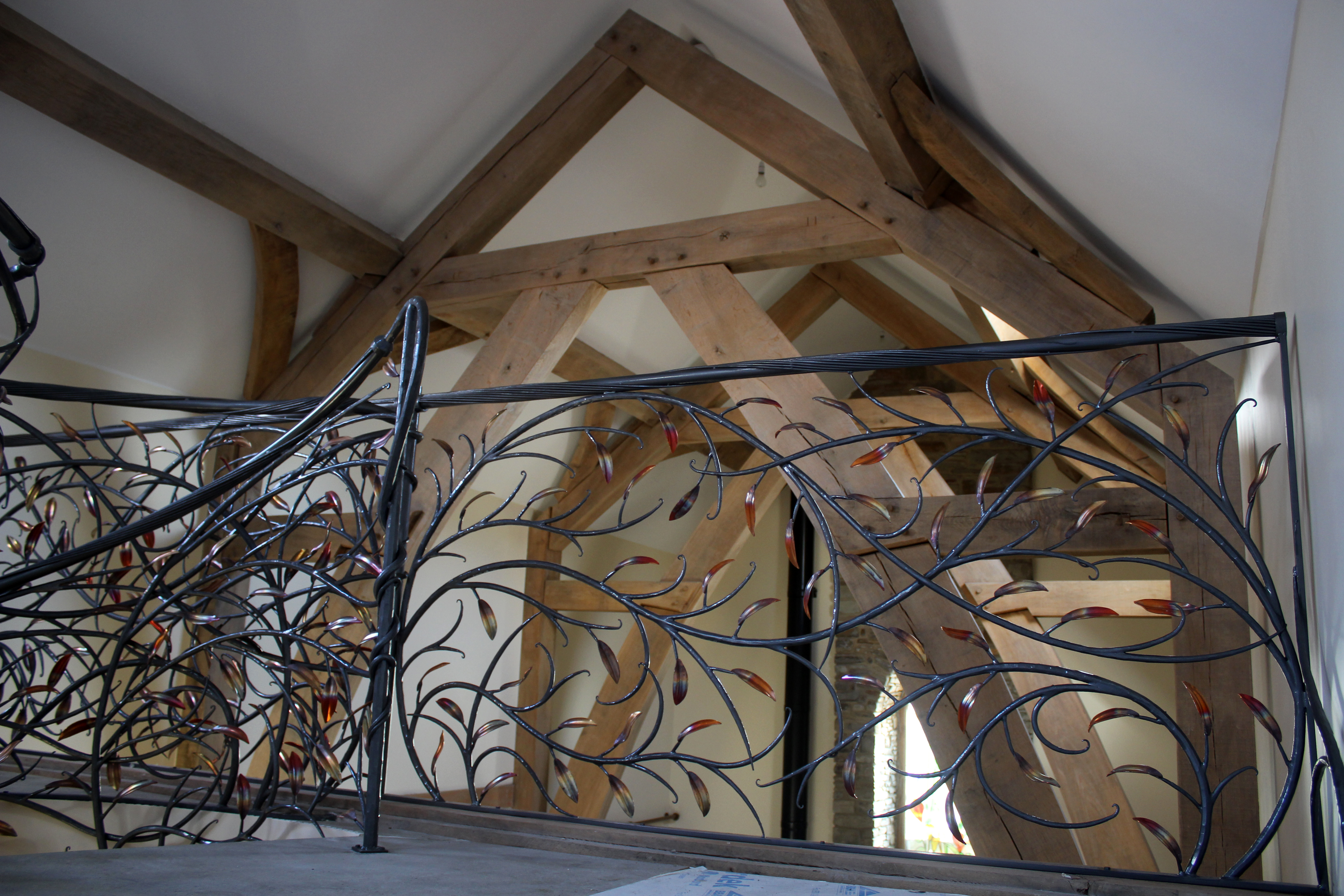 Llannon forged organic spiral staircase with copper leaves Phoenix Forge Wales
