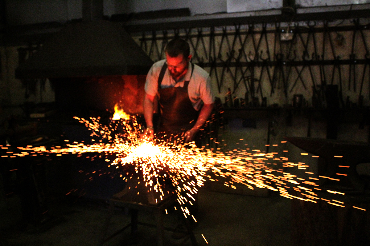 Blacksmith at the anvil — Phoenix Forge classes Wales